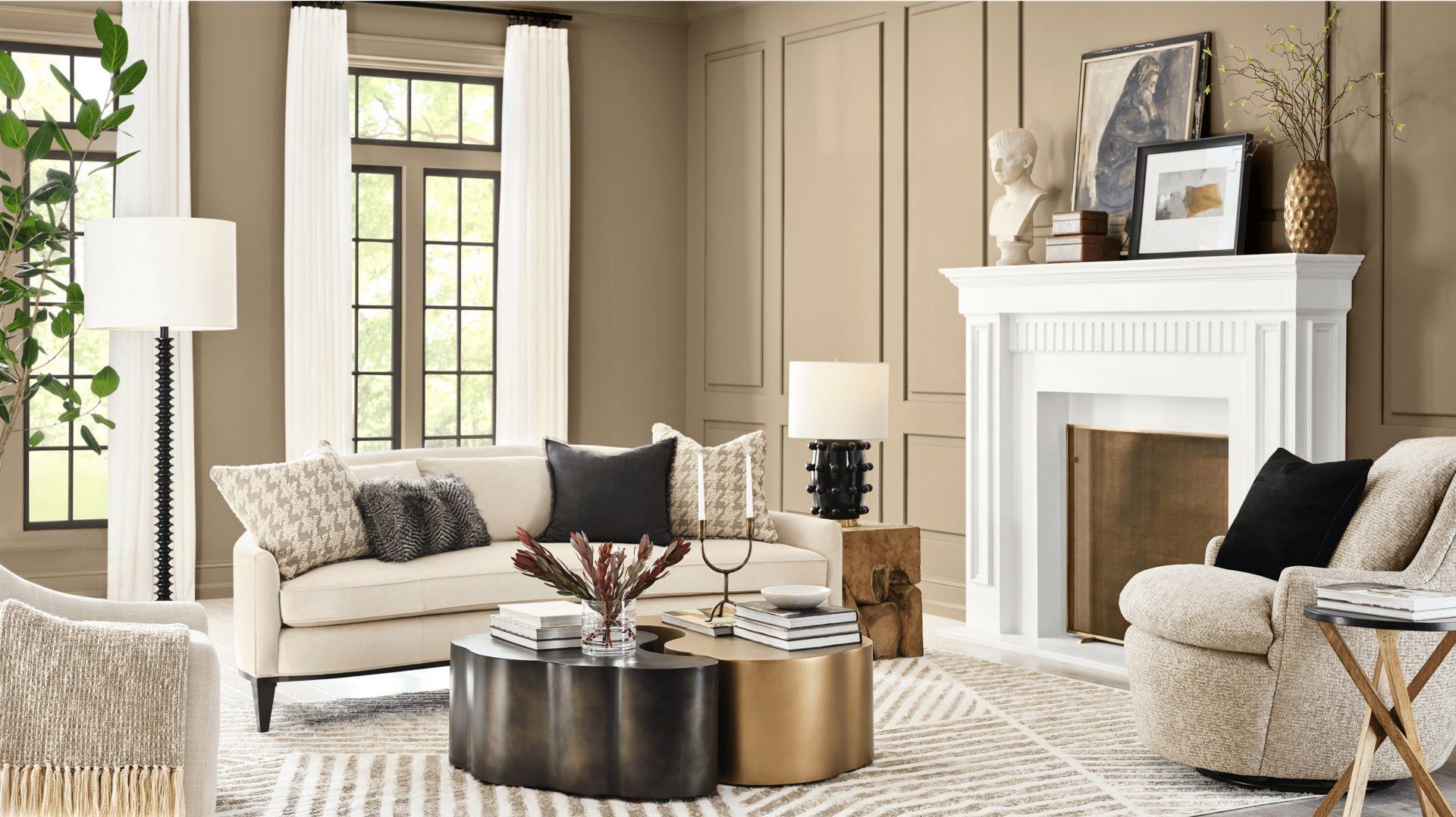 Living room with beige walls, fireplace, sofa, chairs, and patterned rug.