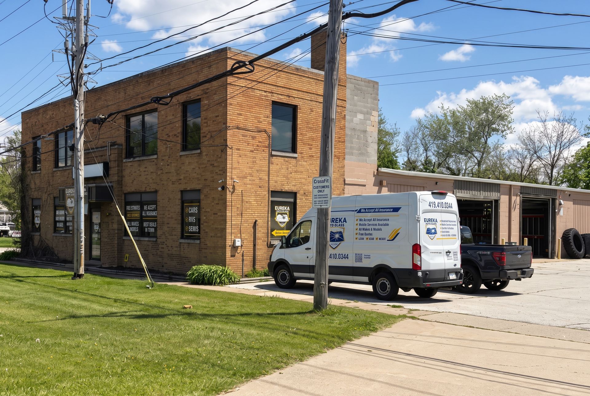 Brick apartment building with a white service van parked beside it under a blue sky