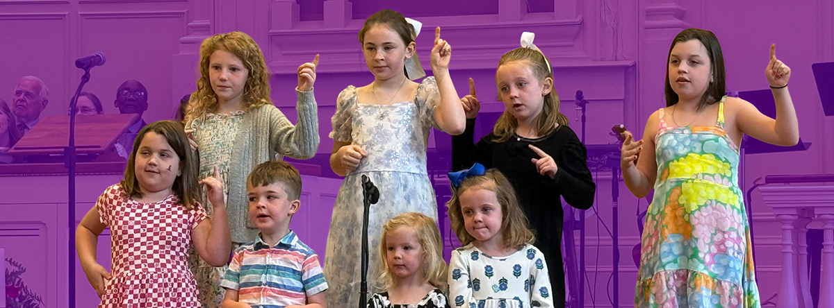 Group of children singing in worship service