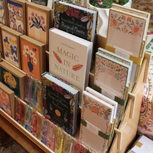 Colorful greeting cards displayed in a shop rack, with floral and patterned designs.