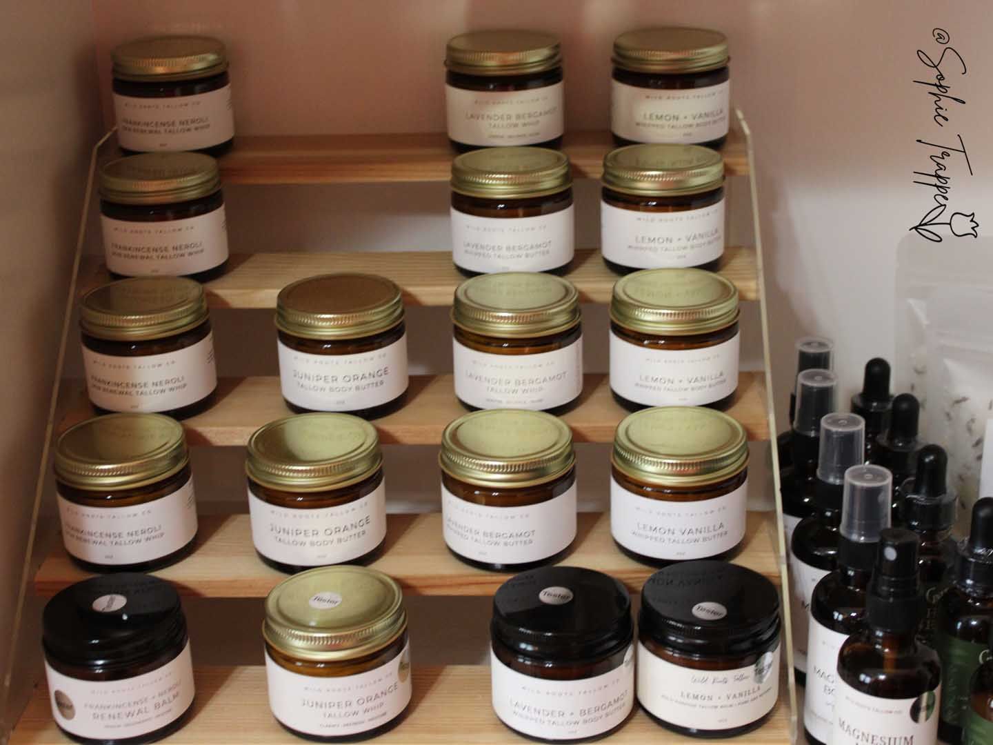 Shelves of assorted jars and bottles with black and gold lids in a storage area