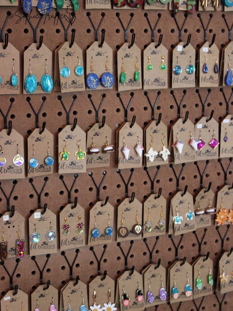 Rows of colorful beaded keychains or tags hanging on a display wall