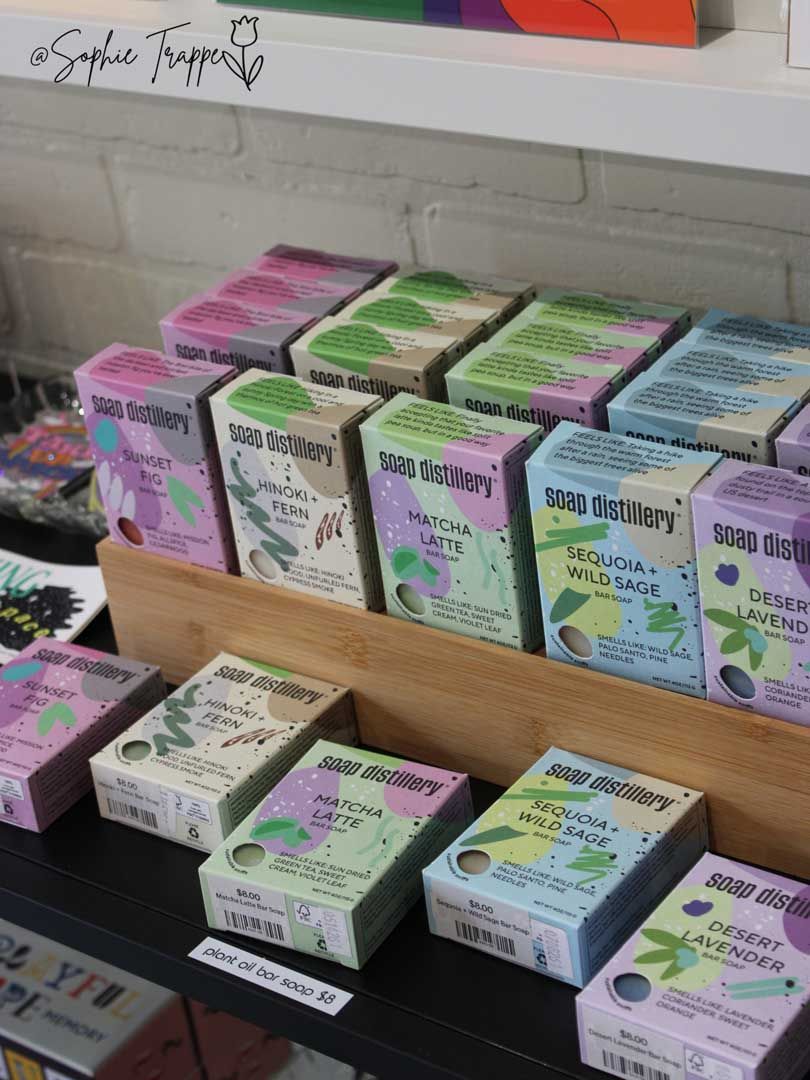 Stacked colorful soap bars in pastel boxes on a store shelf in a retail display