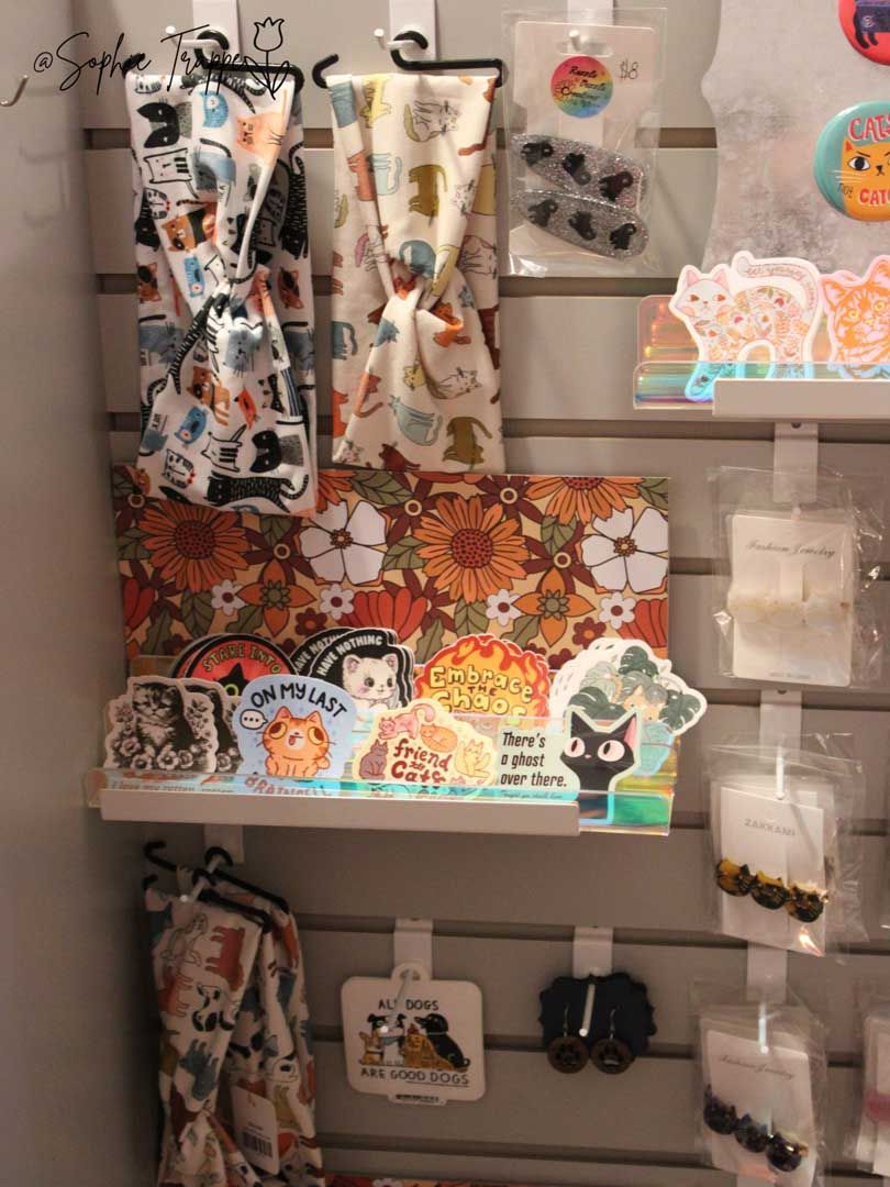 Display of colorful kawaii stationery items on wall shelves and hanging hooks