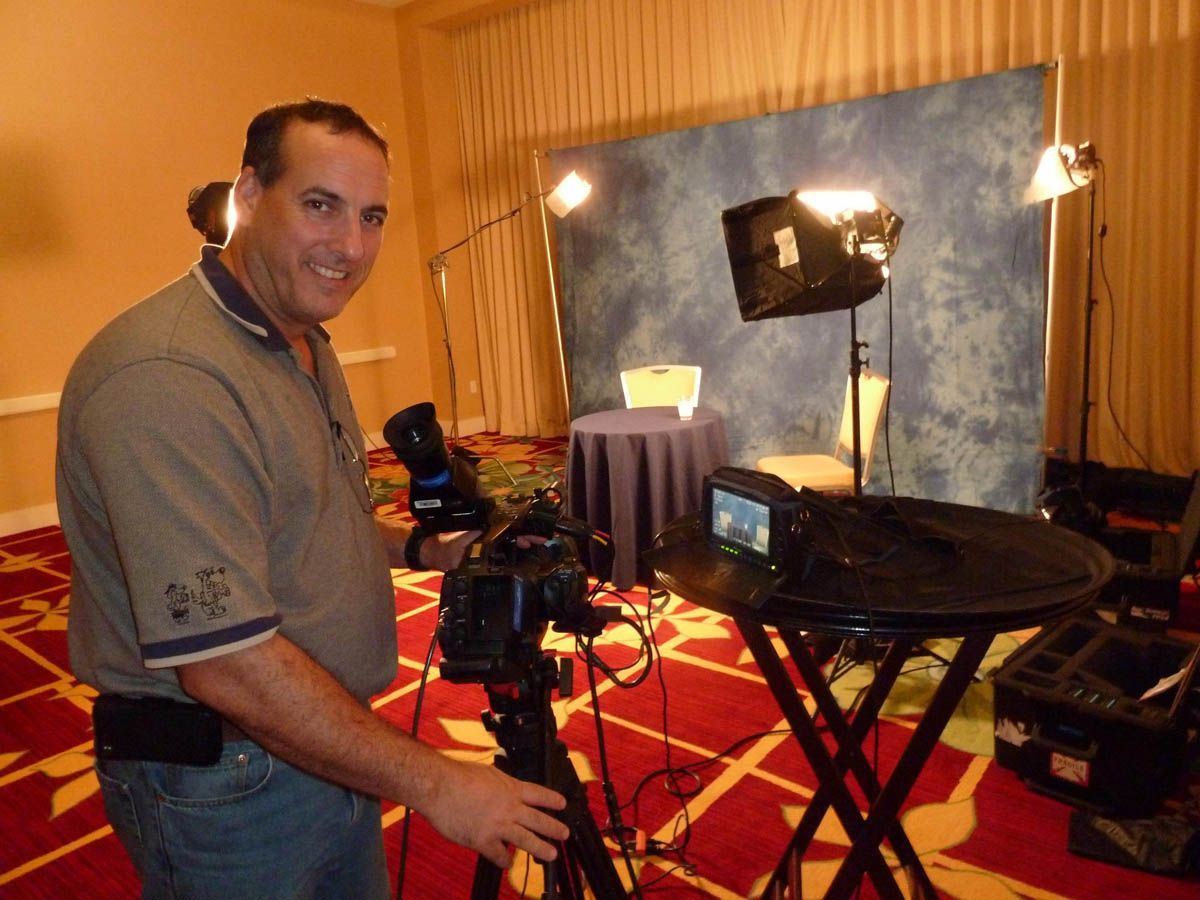 A man is standing in front of a camera in a room