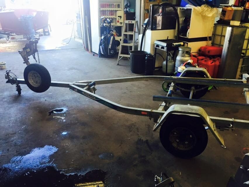 A Trailer Is Sitting in A Garage Next to A Ladder — Don's Marine Repairs in Brisbane Waters, NSW