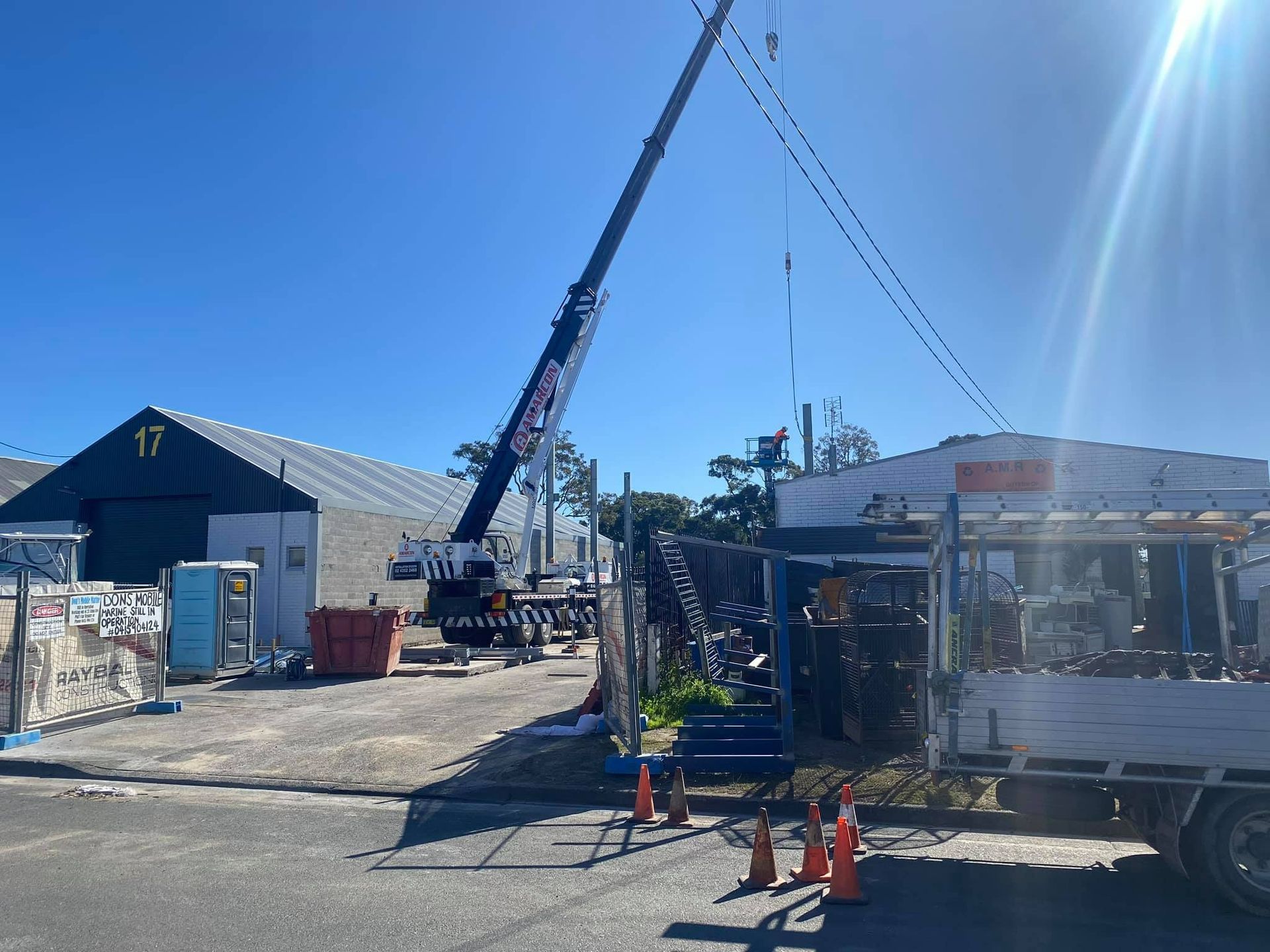 A Large Crane Is Sitting in Front of A Building — Don's Marine Repairs in Umina, NSW