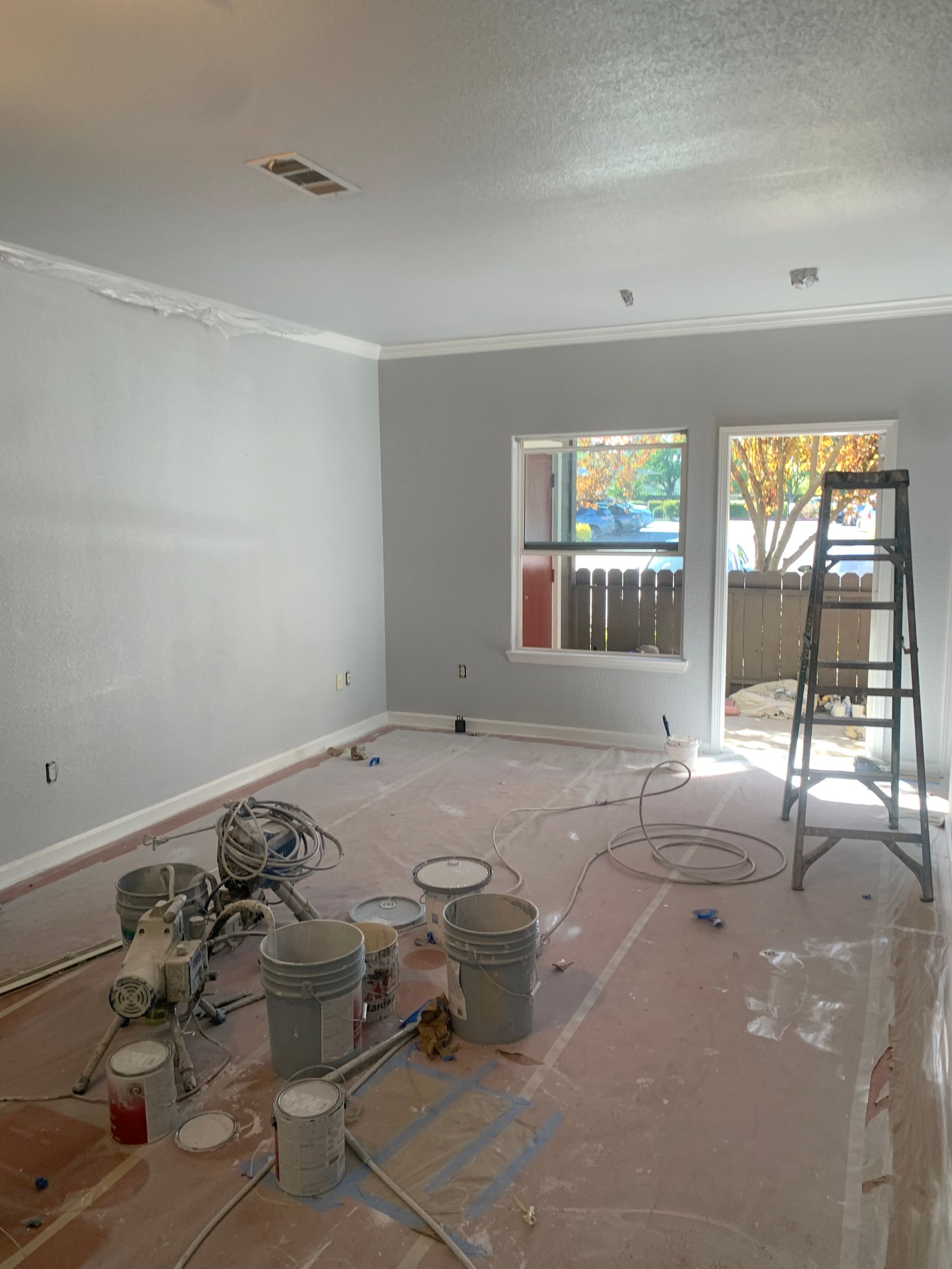 A person is plastering a wall with a spatula.