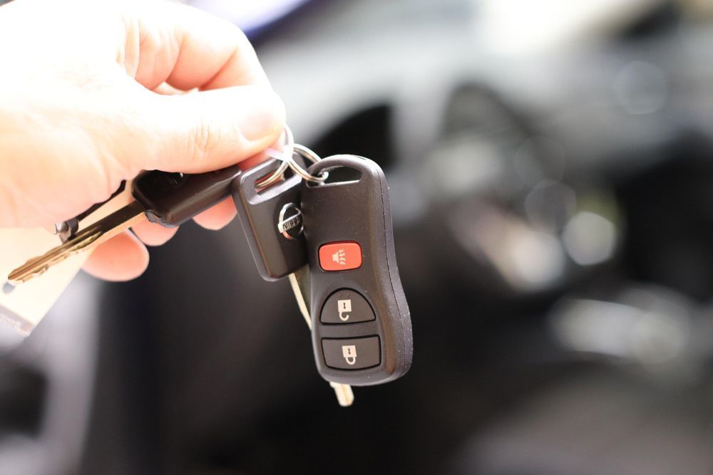 Hand Holding Car Keys and Key Fob in Star, ID