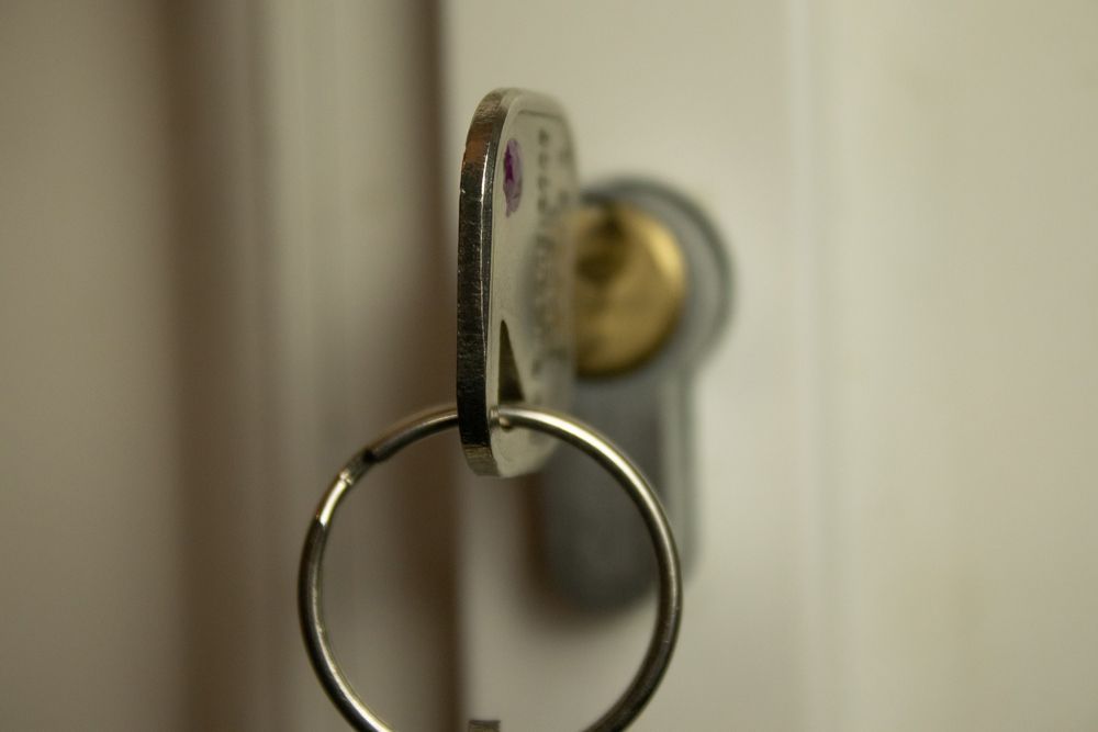 Key ring hanging in a lock on a door, close-up.