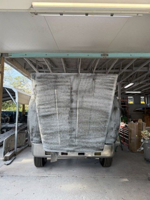 Shrink-wrapped cargo pallets on a truck in a covered garage area