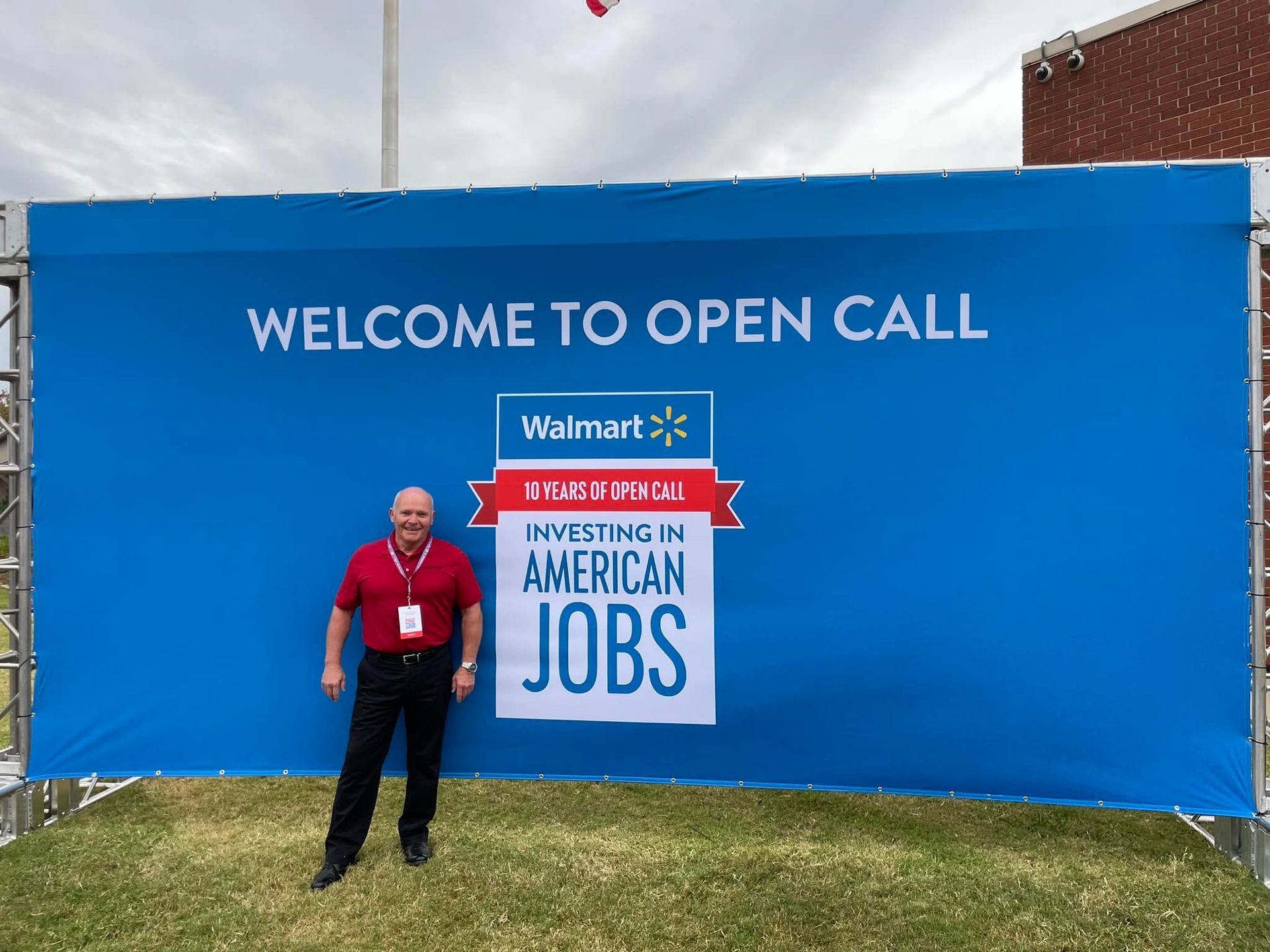 Blue banner reading “WELCOME TO OPEN CALL” with Walmart logo and “Investing in American Jobs,” beside a man outdoors.