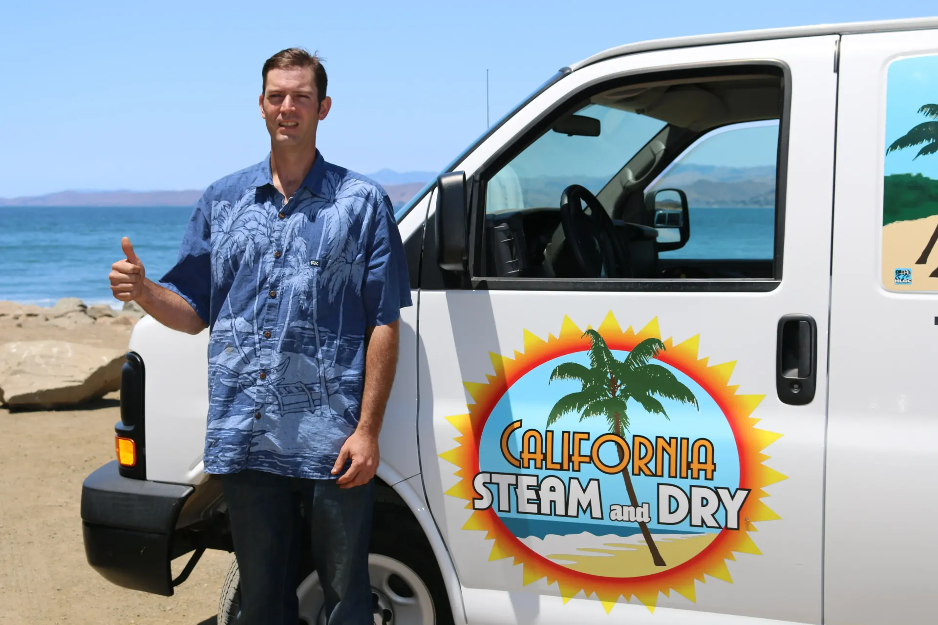 A man is standing in front of a california steam dry van