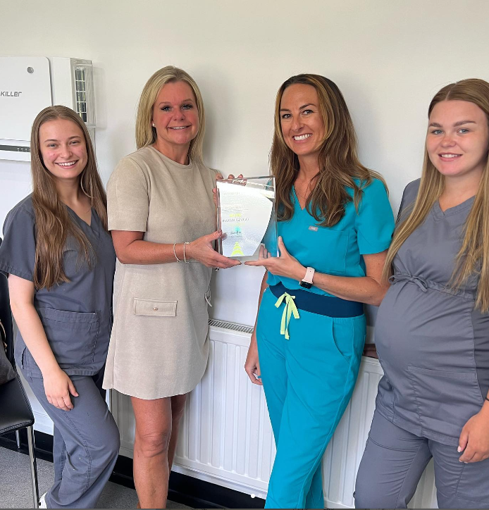 team at Ridgeway Dental holding Invisalign Elite Status award