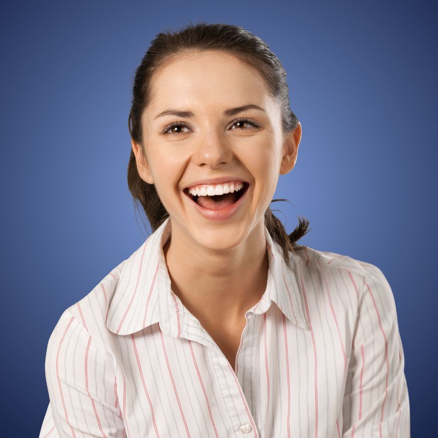 Smiling woman in a striped shirt against a blue background