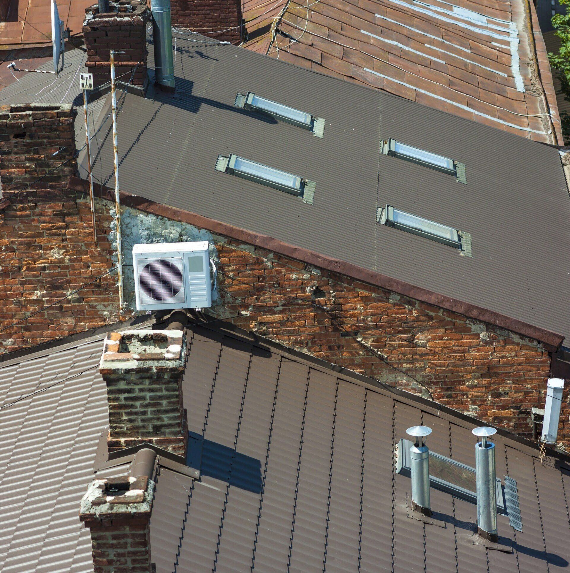 An aerial view of a roof with a chimney and an air conditioner