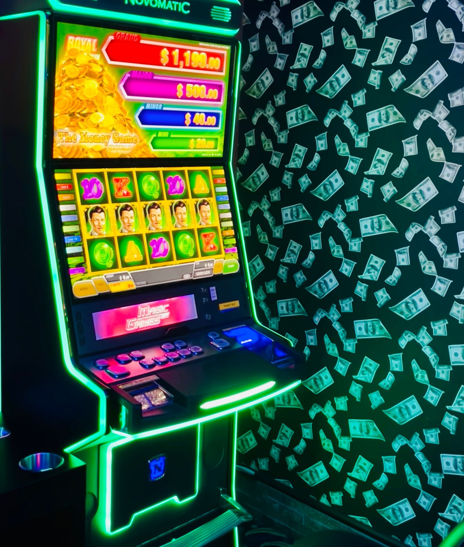 A slot machine is sitting in front of a wall with money on it.