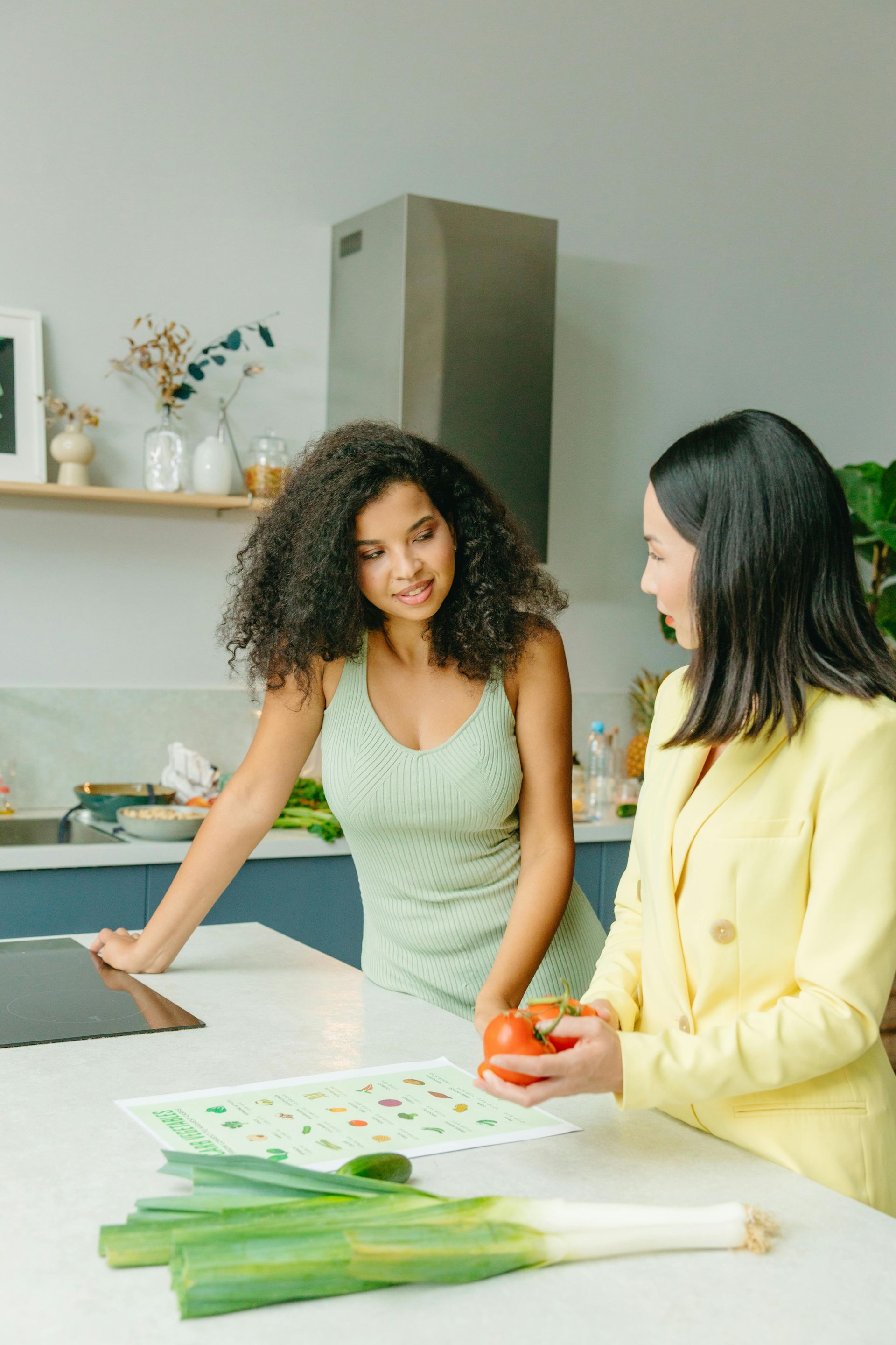 Two people preparing vegetables together in a bright kitchen