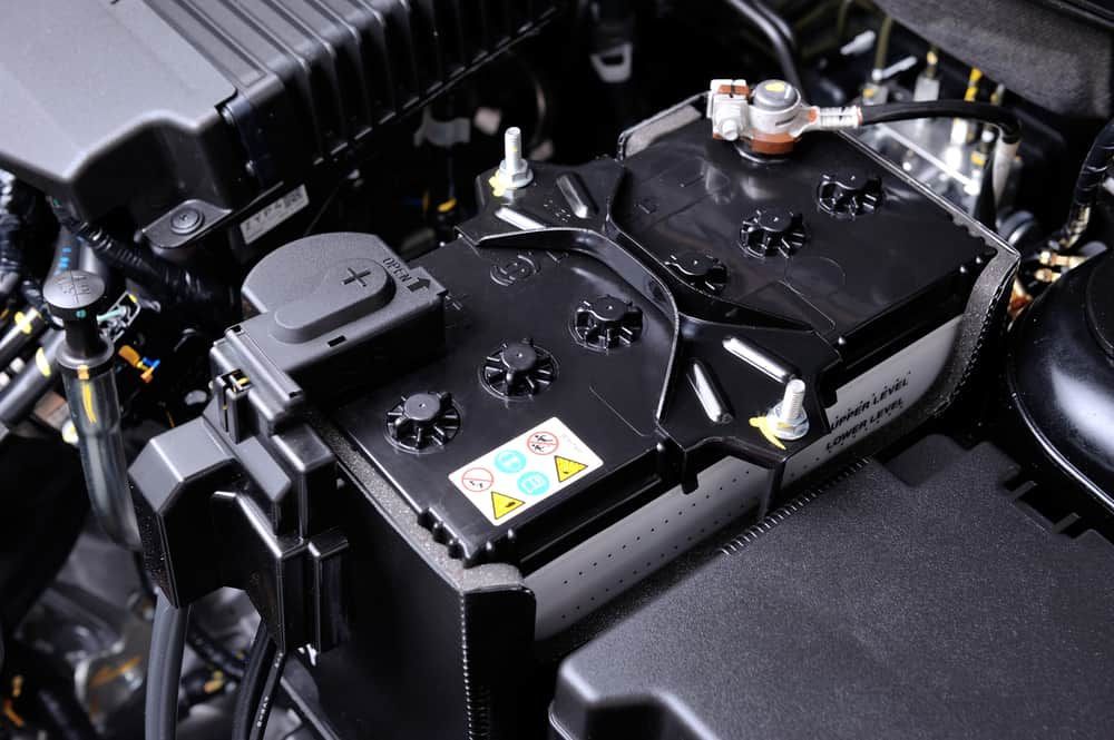 A Car Battery is Sitting Under the Hood of a Car — FNQ Filters & Parts In Mareeba, QLD