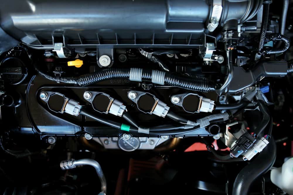 A Close Up of a Car Engine With Spark Plugs — FNQ Filters & Parts In Mareeba, QLD