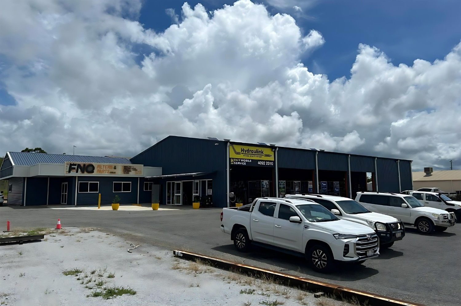 A Store Front With a Sign That Says FNQ on It — FNQ Filters & Parts In Mareeba, QLD