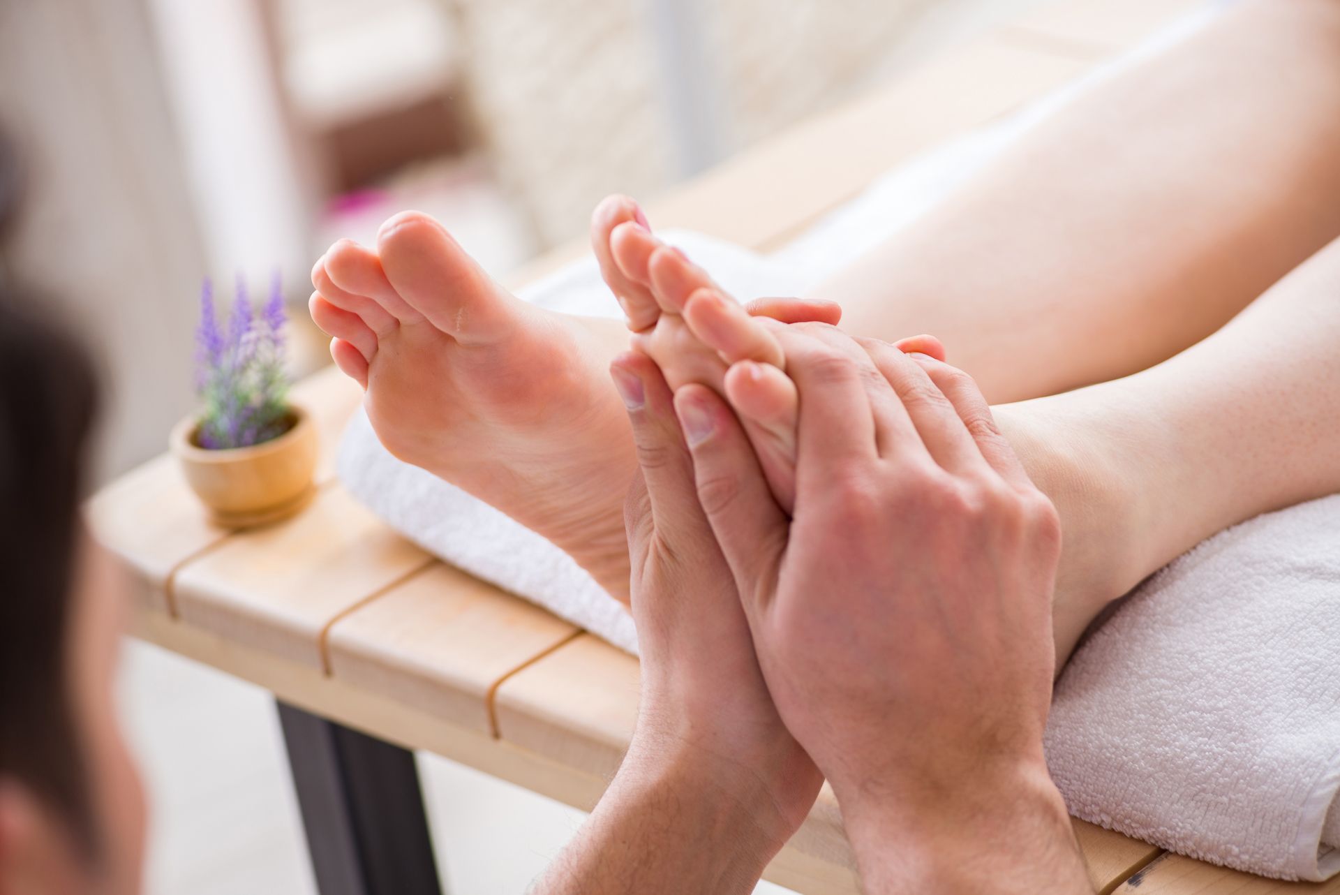 A Man is Giving a Woman a Foot Massage in a Spa