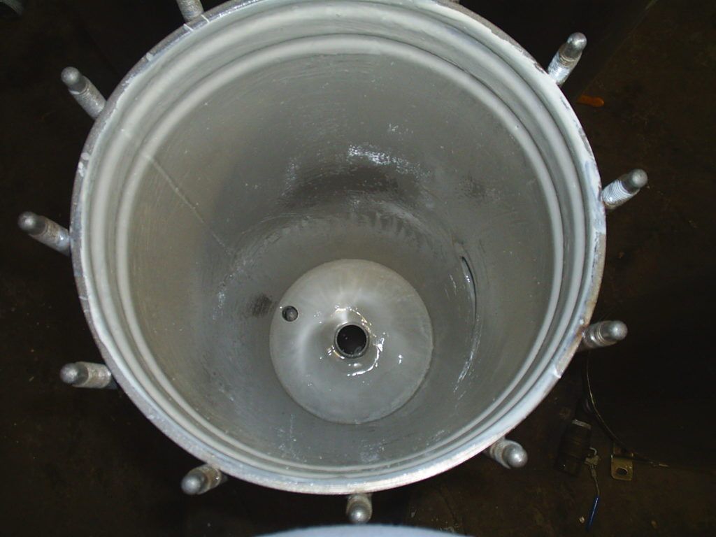 Top-down view of an empty gray metal pot or bucket with handles on a dark surface.