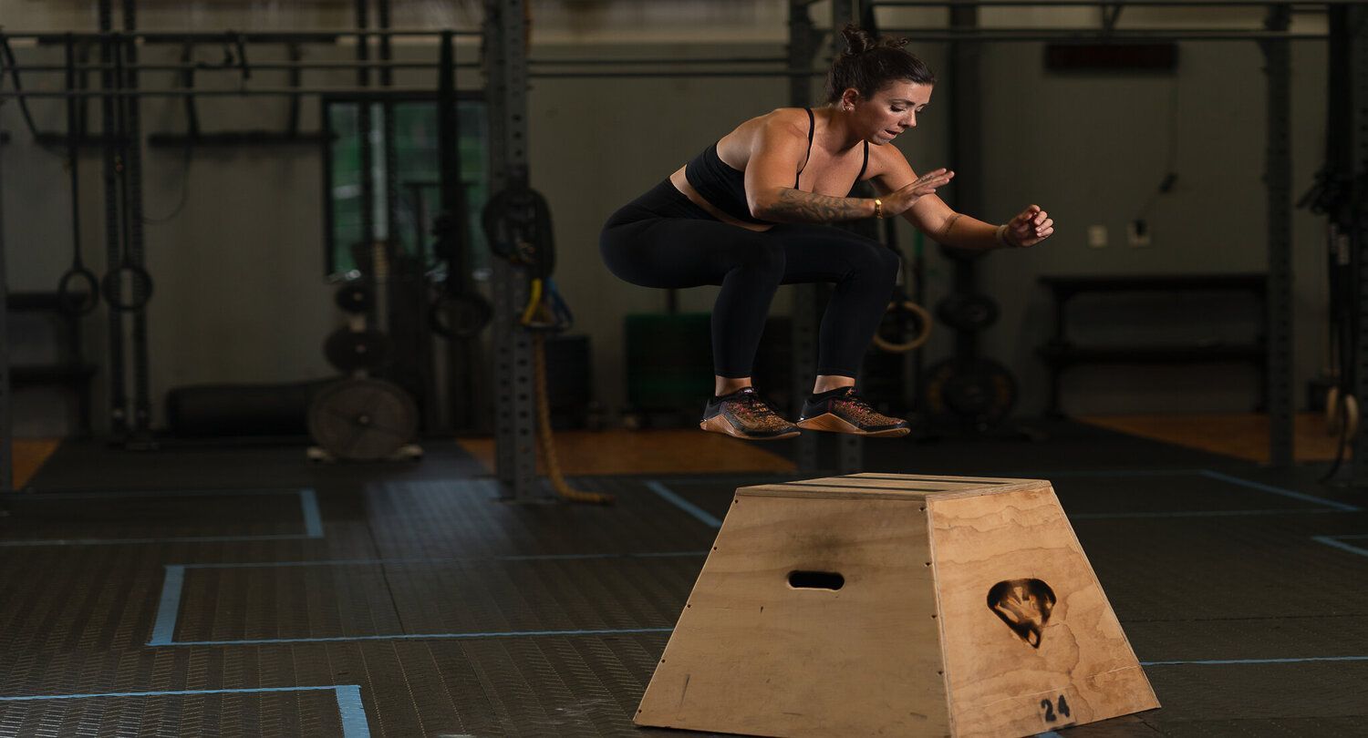 A woman practicing box jumps.