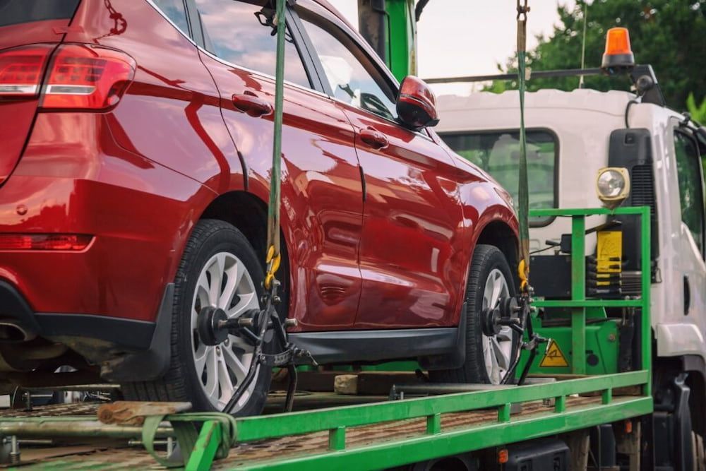 Red Car Being Towed on a Flatbed Tow Truck — Fulgi's South Coast Automotive and Dismantling in Shellharbour, NSW