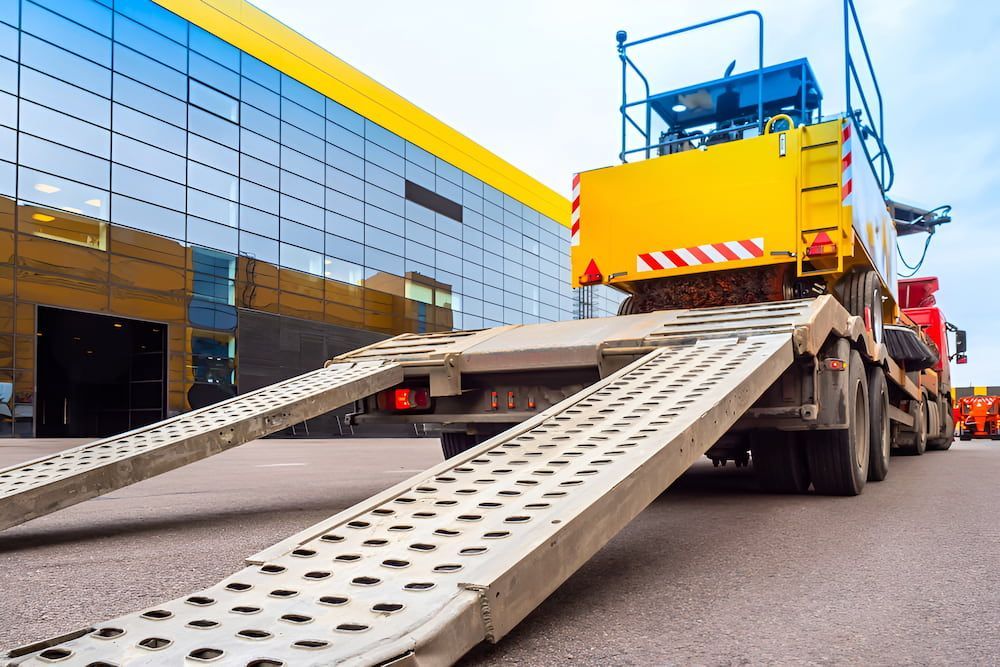 A Yellow and Red Lowboy Trailer — Fulgi's South Coast Automotive and Dismantling in Shellharbour, NSW