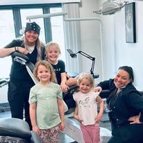 Group of people in a dentist's office pose for a photo.