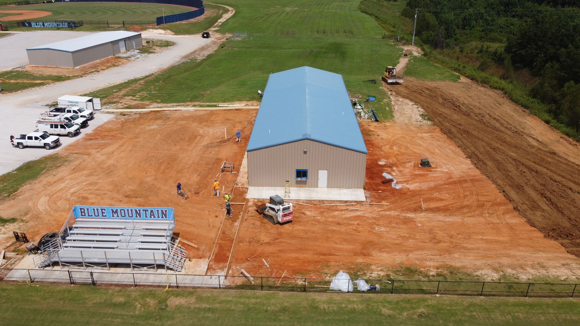 An aerial view of a building under construction in a field