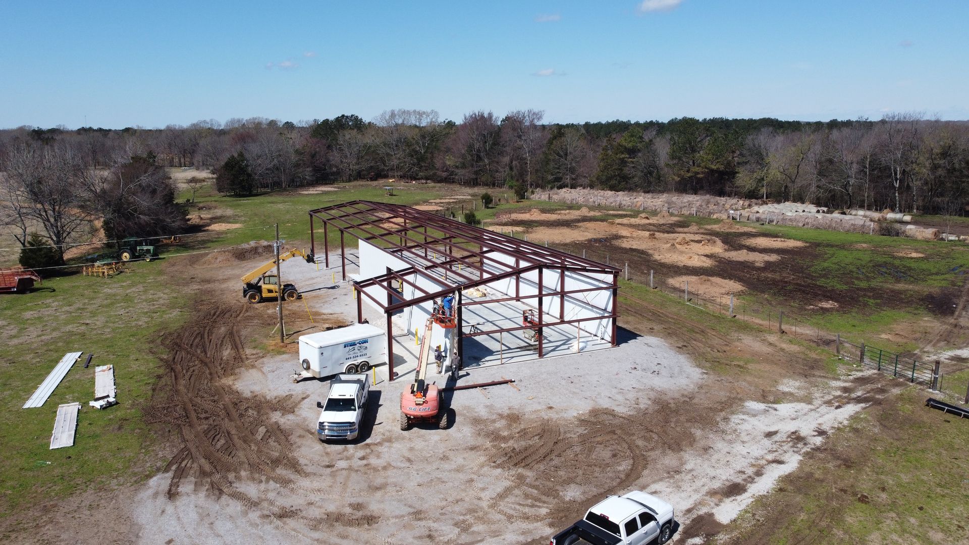 An aerial view of a building under construction in a field.