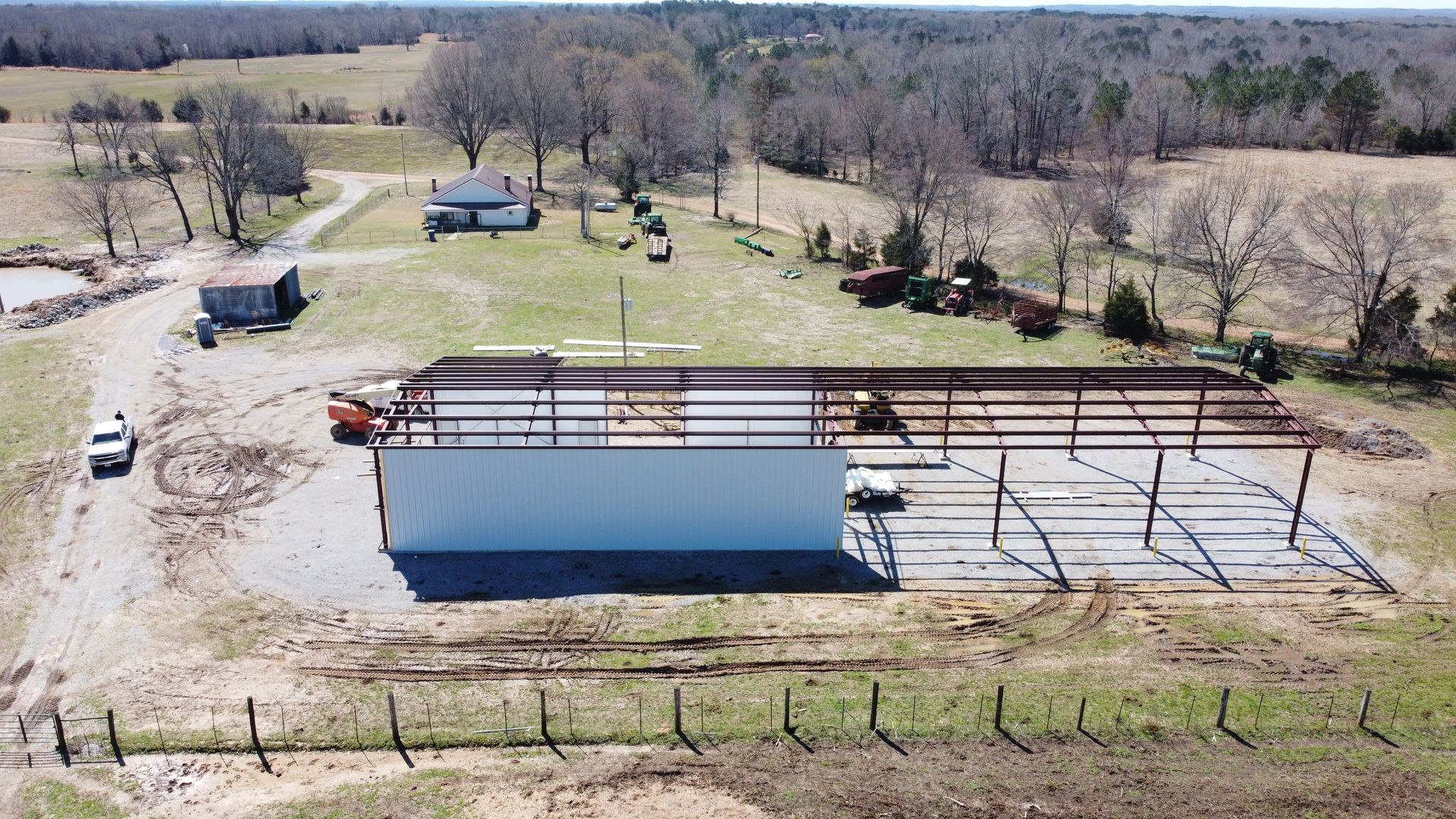 An aerial view of a building under construction in a field