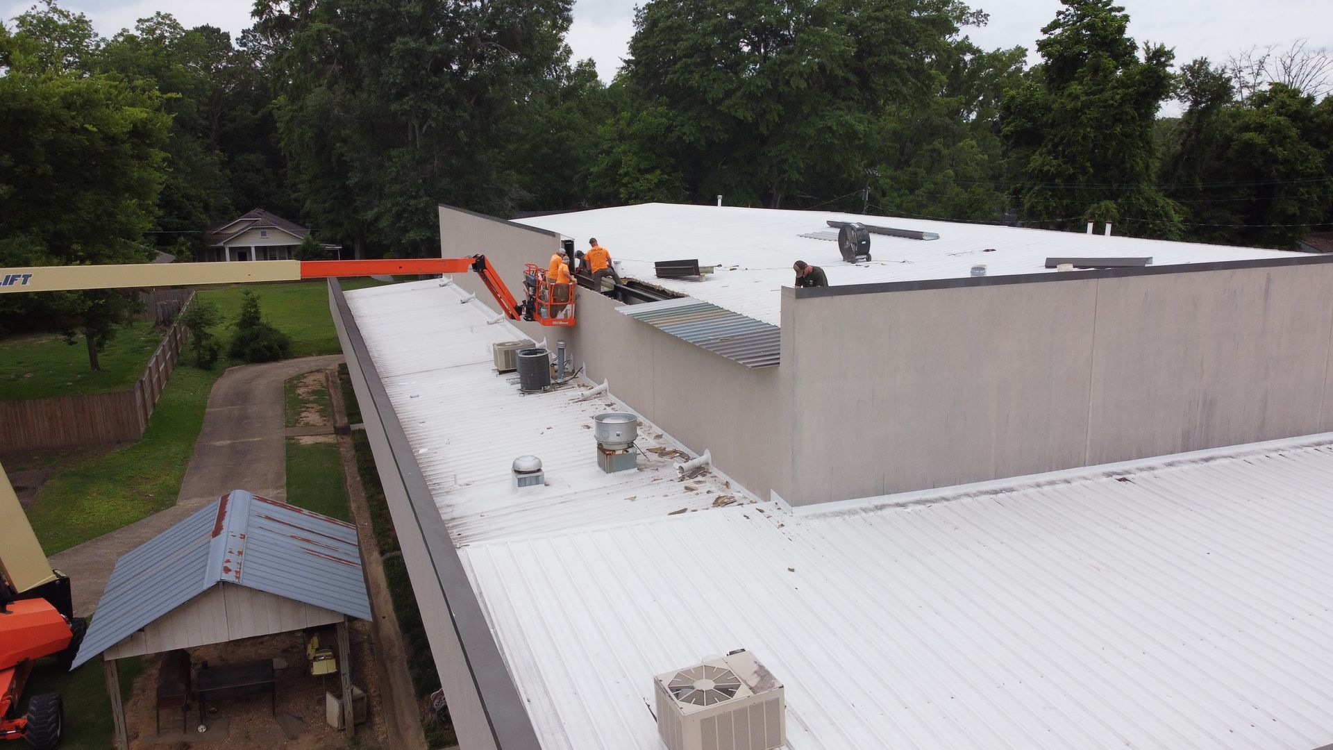 A group of men are working on the roof of a building.