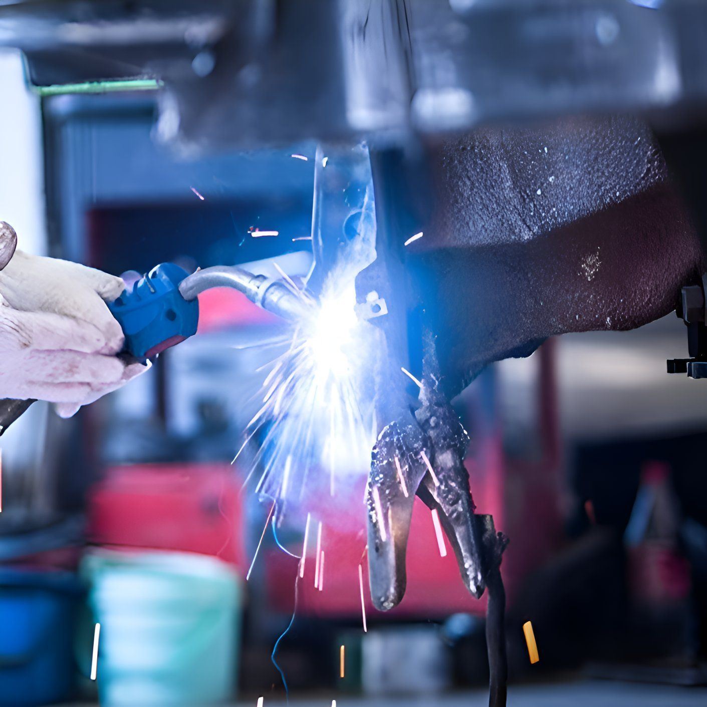 A Person Is Welding A Piece Of Metal In A Garage — Sno's Welding In Ciccone, NT
