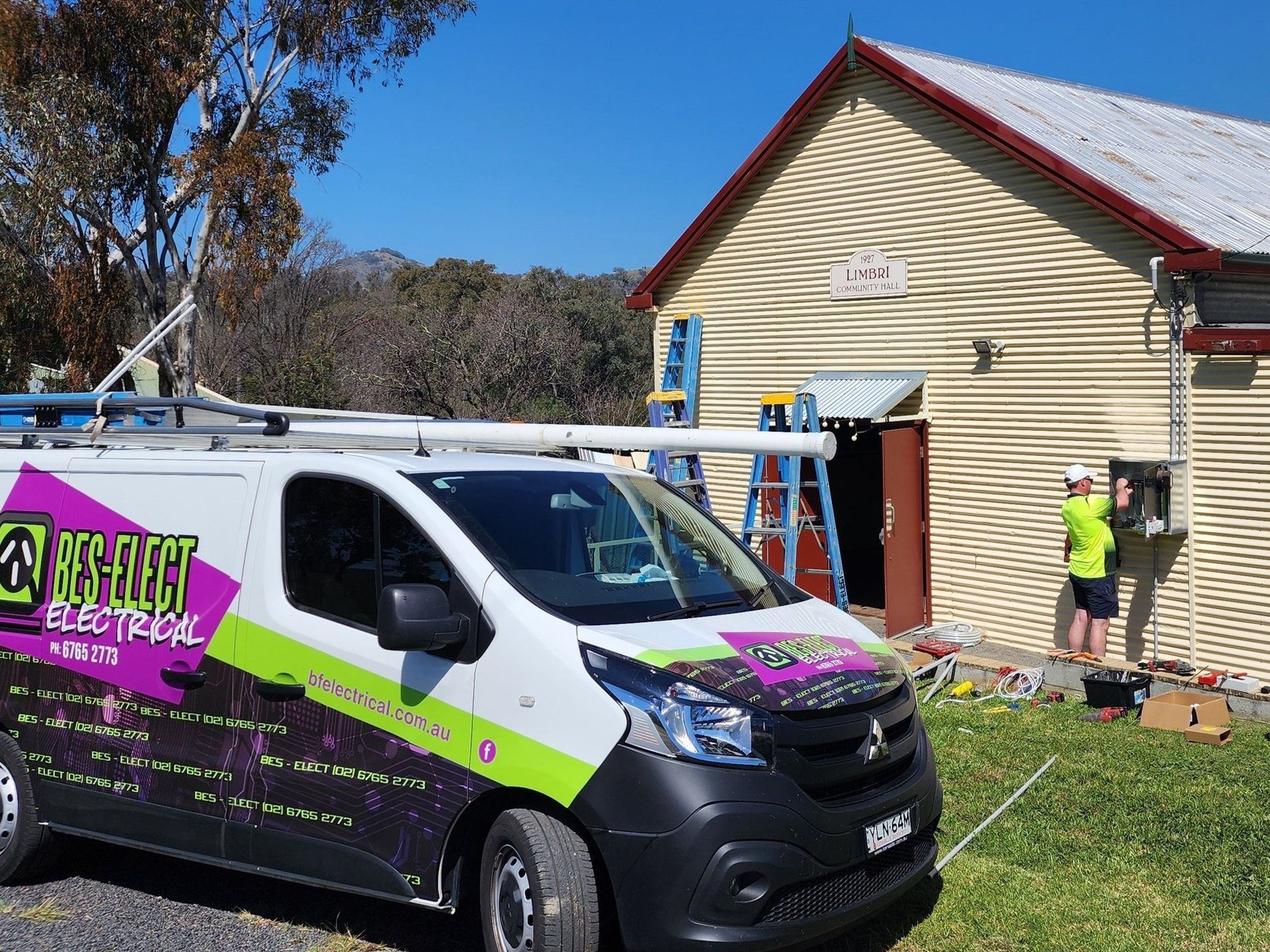 Utility Van and Workers Repairing a Beige House Electrical — Bes-Elect Electrical in Taminda, NSW