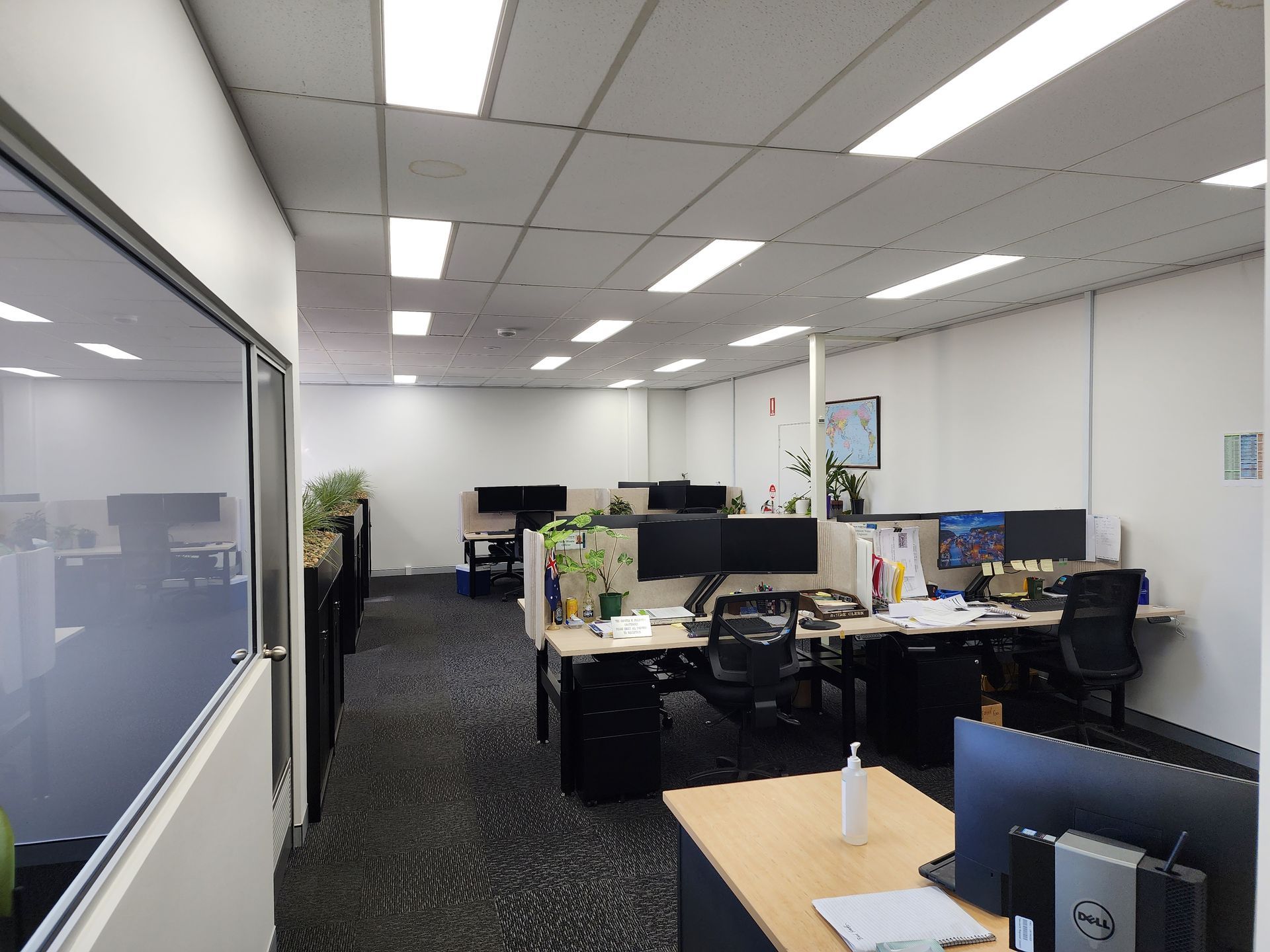 Open Plan Office with Desks and Computer Monitors and Bright Overhead Lighting — Bes-Elect Electrical in Taminda, NSW