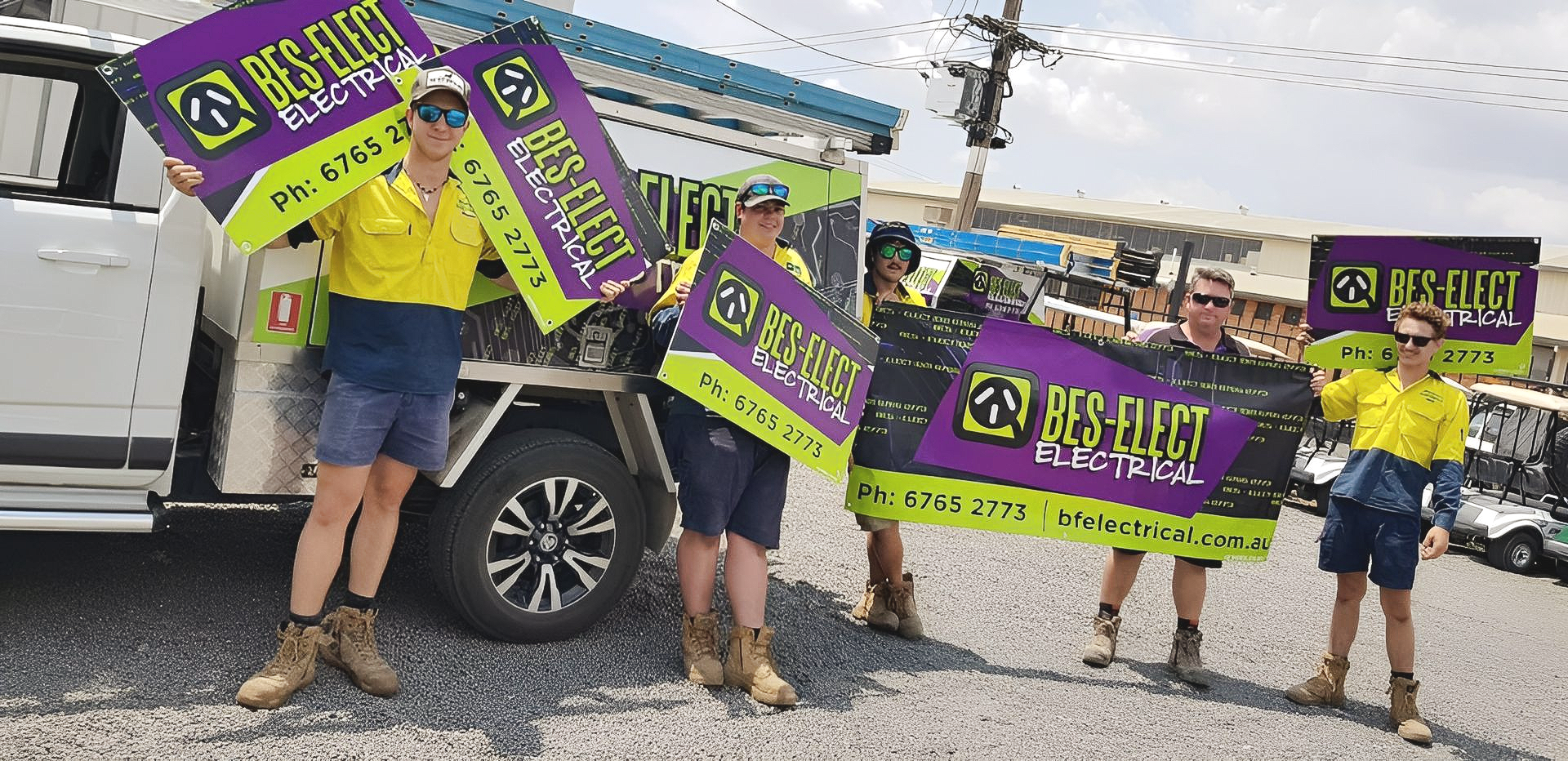 People Holding Purple Protest Signs Beside a White Pickup Truck on A Street — Bes-Elect Electrical in Taminda, NSW