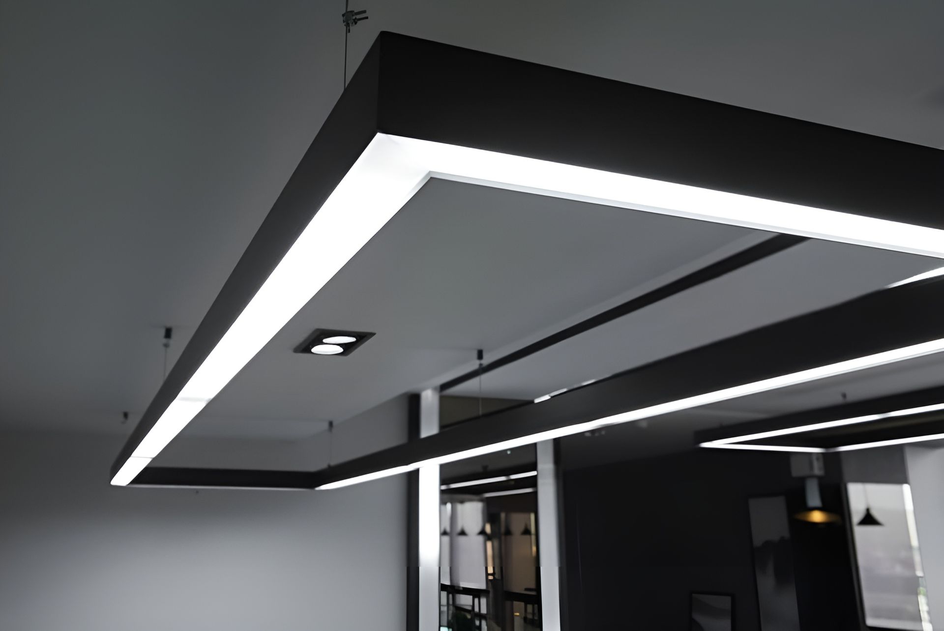 Modern Interior with Angular Black Ceiling Panels and Bright Linear Led Strip Lights — Bes-Elect Electrical in Taminda, NSW