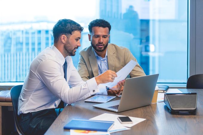 Business People Working On A Document — Spokane, WA — Omlin Gunning & Assoc