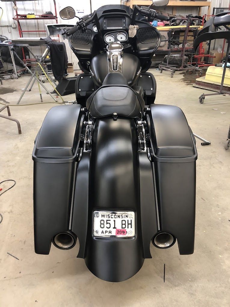A black motorcycle with a license plate that says ho 158