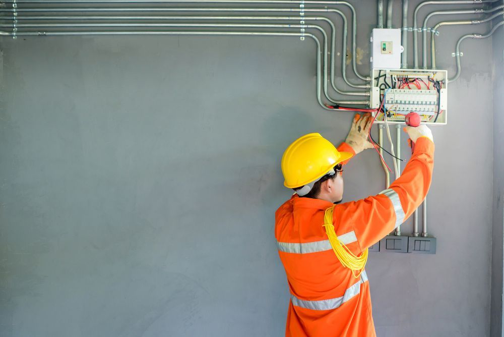 Electrician performing testing and installation of electrical switches — Electrician in Sawyers Gully NSW
