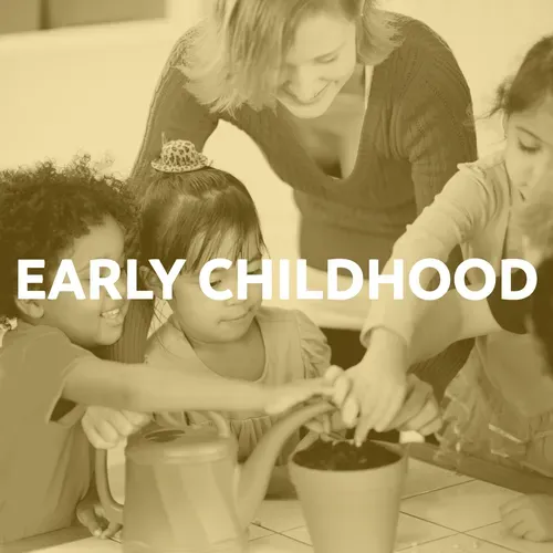 A teacher and children planting a seed in a pot at a table.