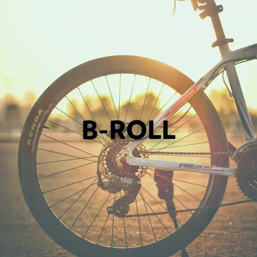 Bicycle wheel close-up with gears, sunlight, and the word