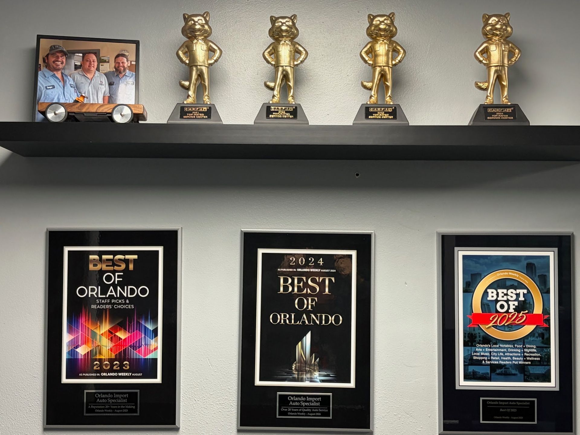 Shelf with golden cat trophies and 