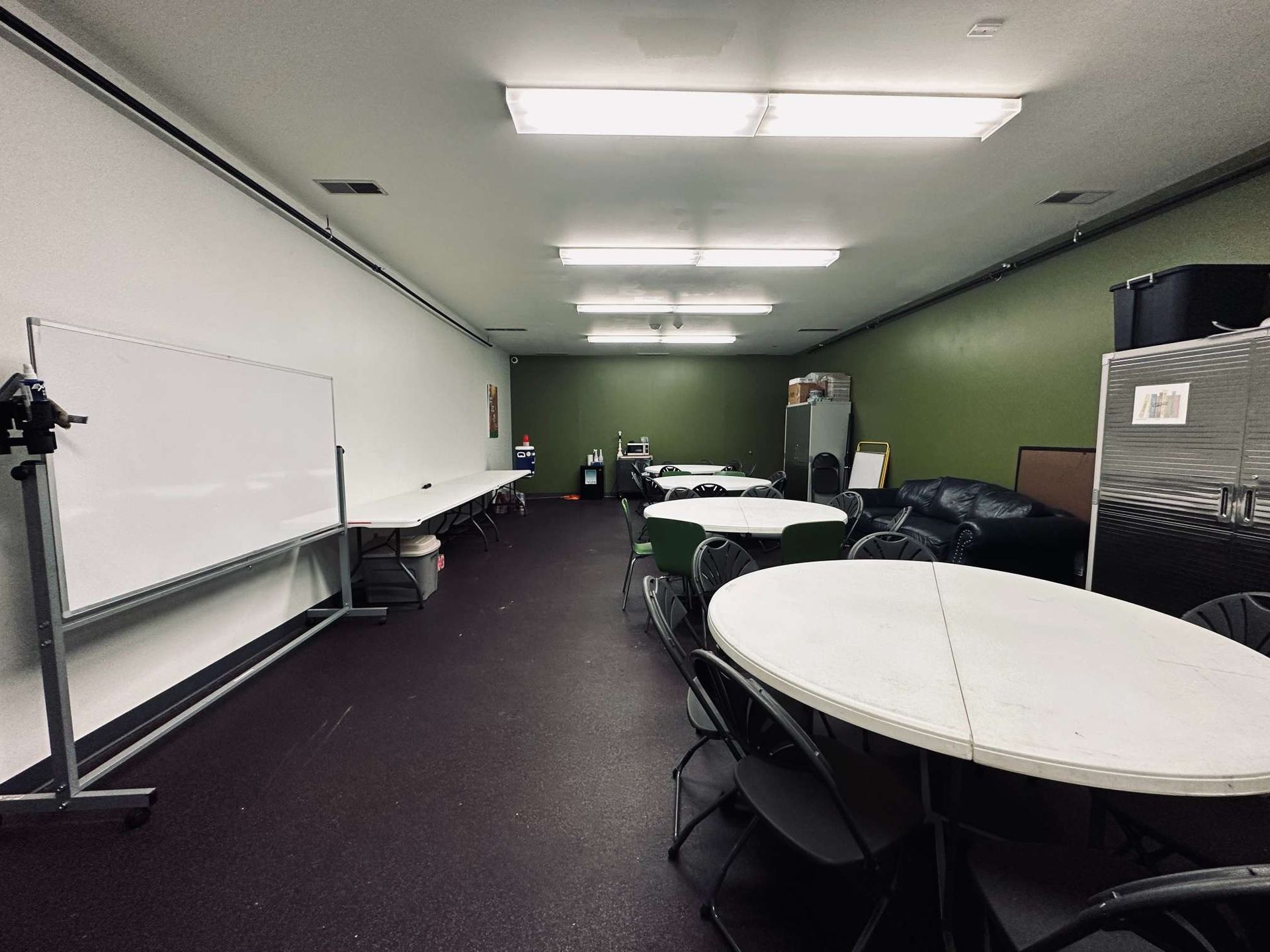 A large room with tables and chairs in it