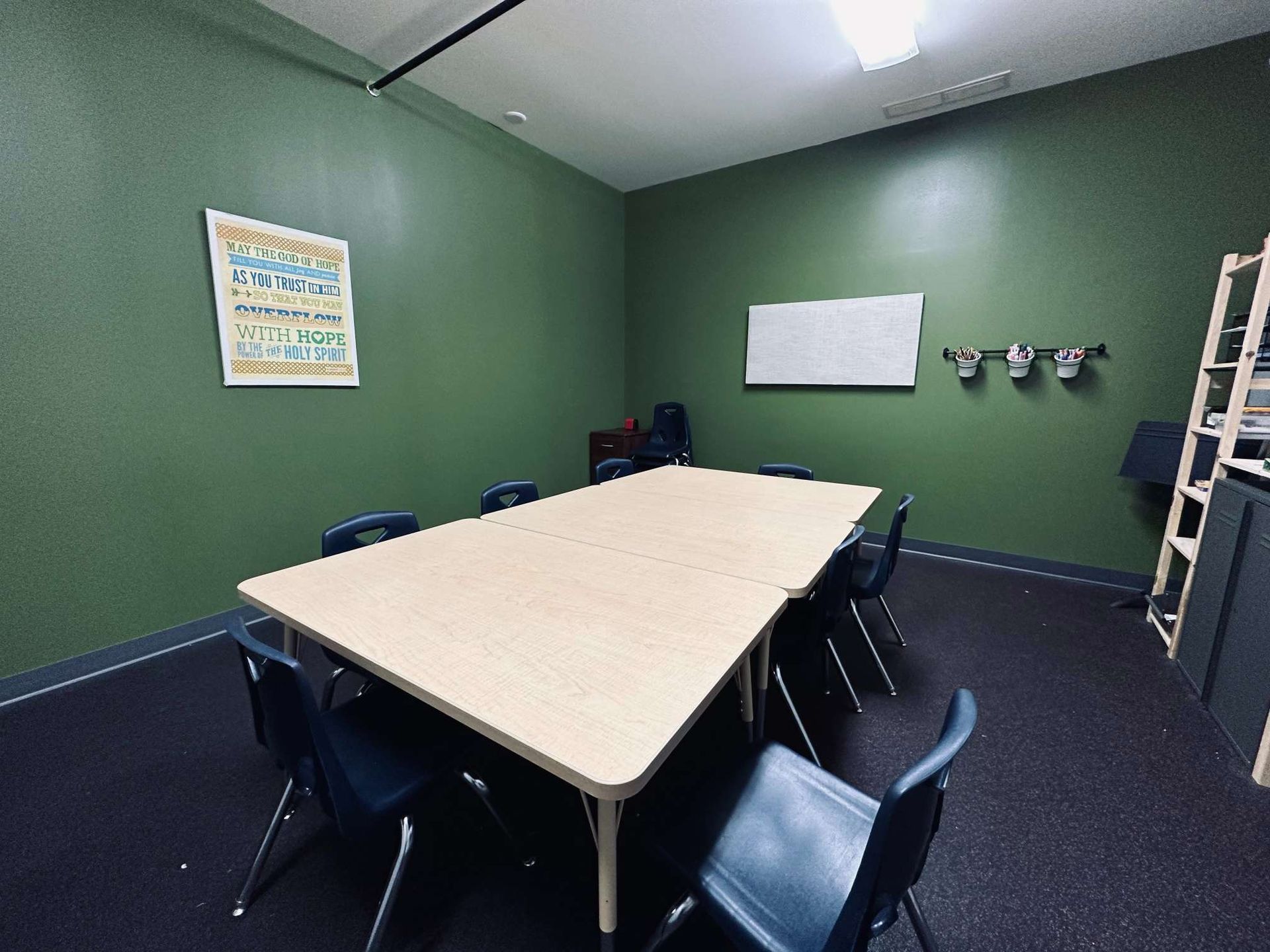A conference room with a long table and chairs.