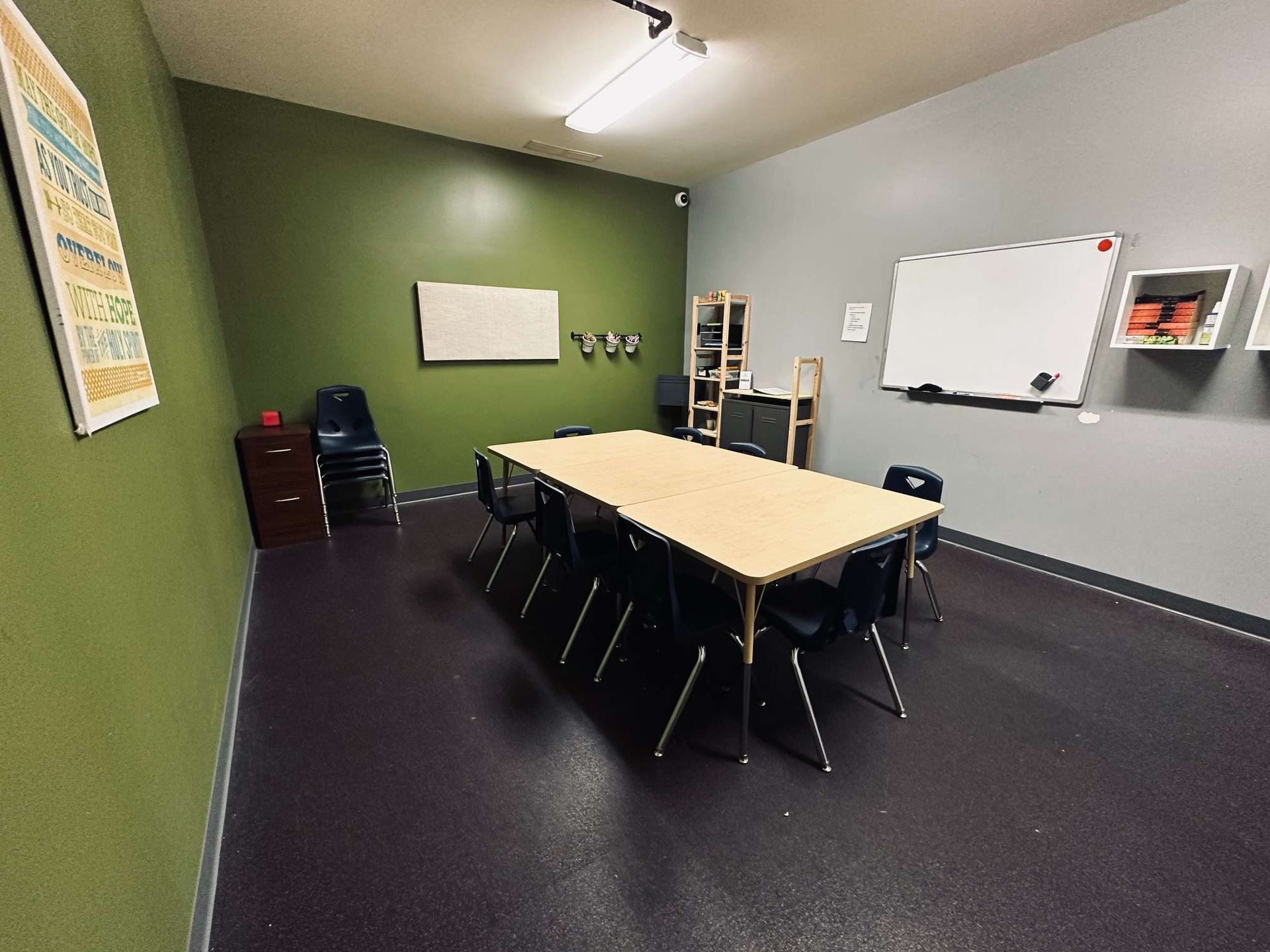 A conference room with a long table and chairs.