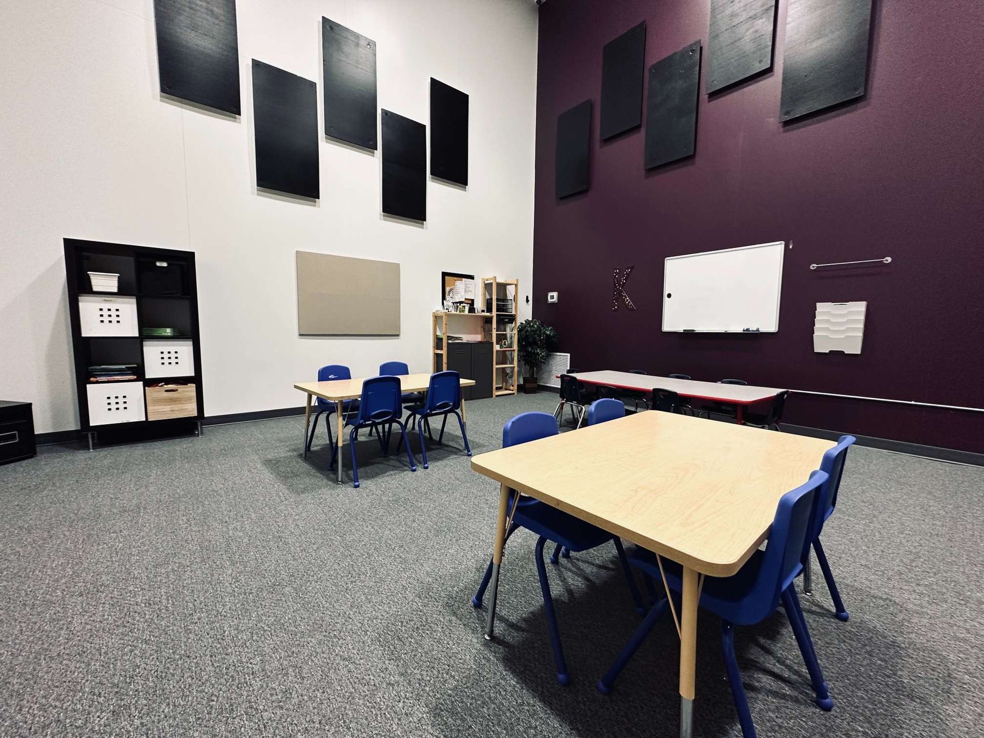 A room with a table and chairs in it